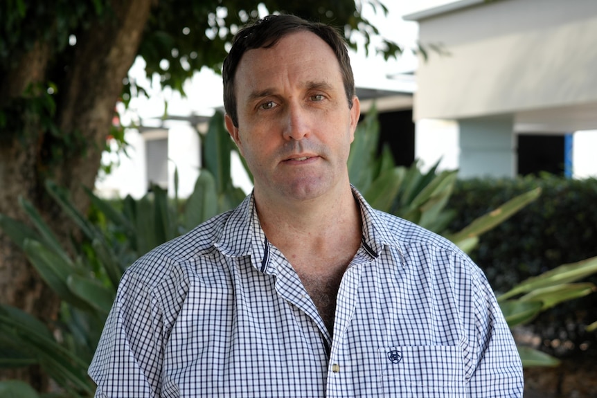A man in a checked blue shirt