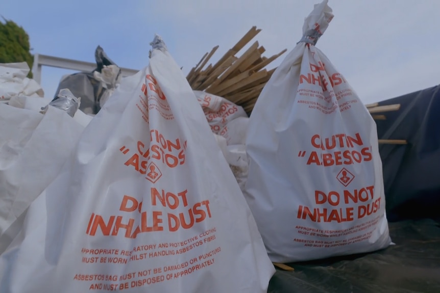 Bags of asbestos in the back of a truck.