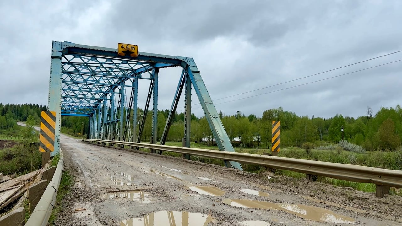 A blue bridge over a river.