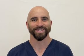 a bald man with a beard smiling