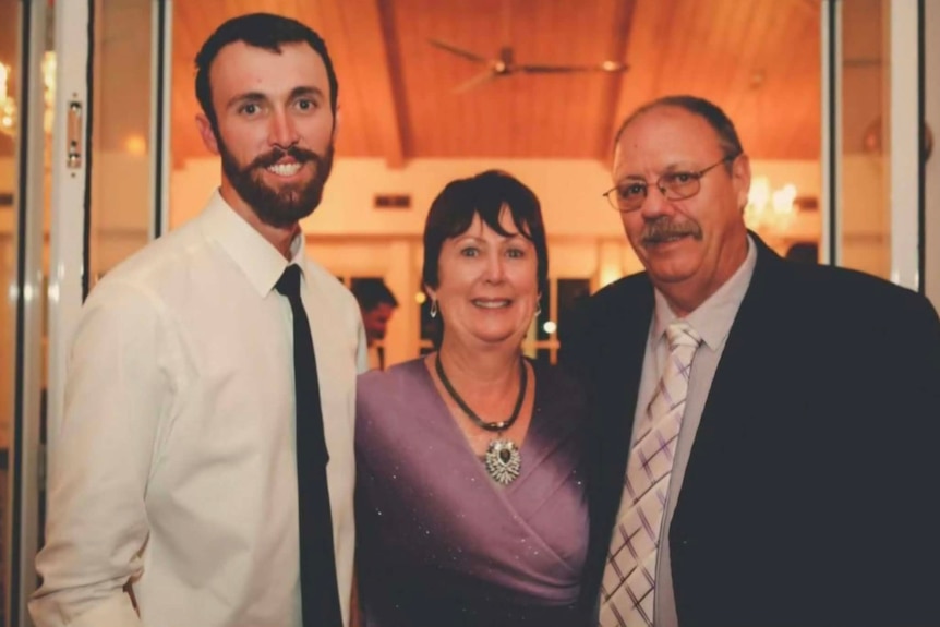 A young man, with an older woman and man.
