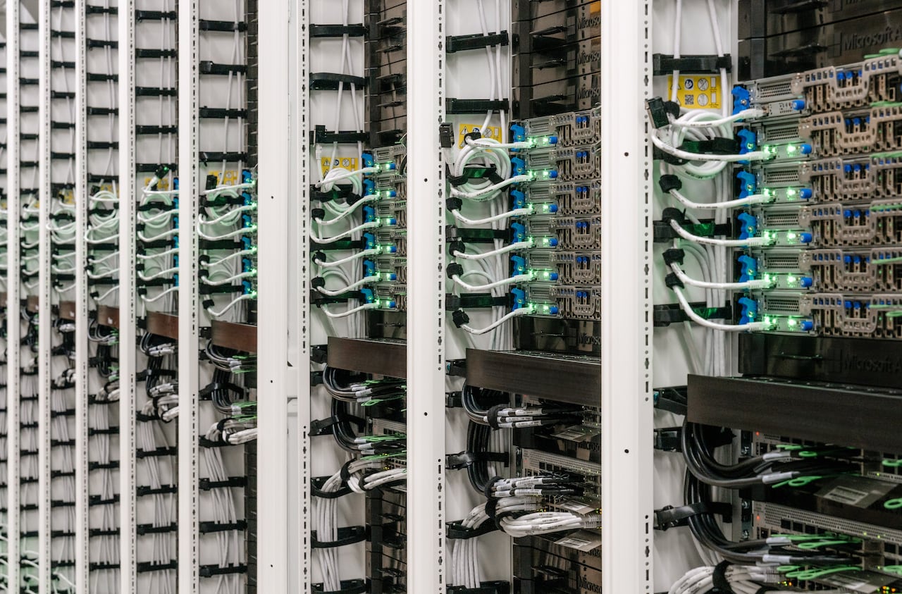 Rows of cables and computer hardware are shown.