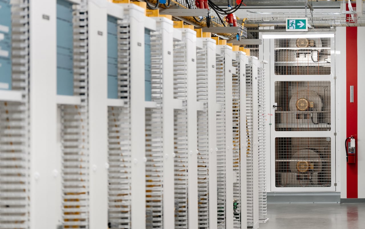 A few fans are shown at the end of rows of computer equipment.