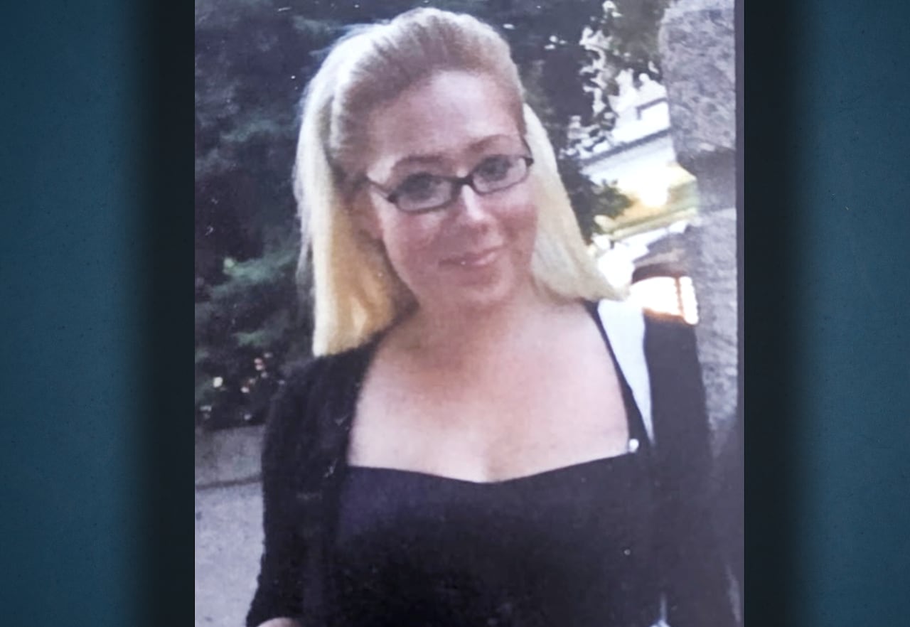A photo a girl with blonde hair and glasses.