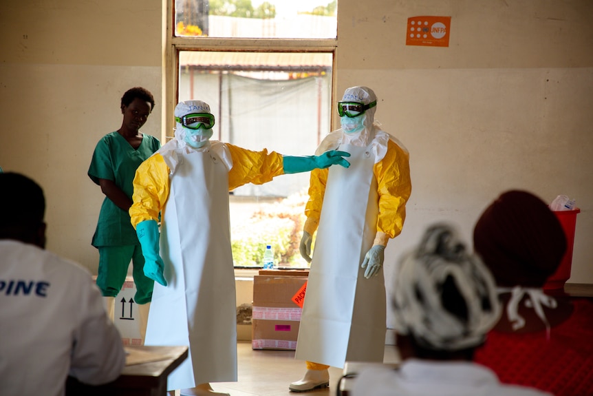 People in PPE undergo training at a medical centre.