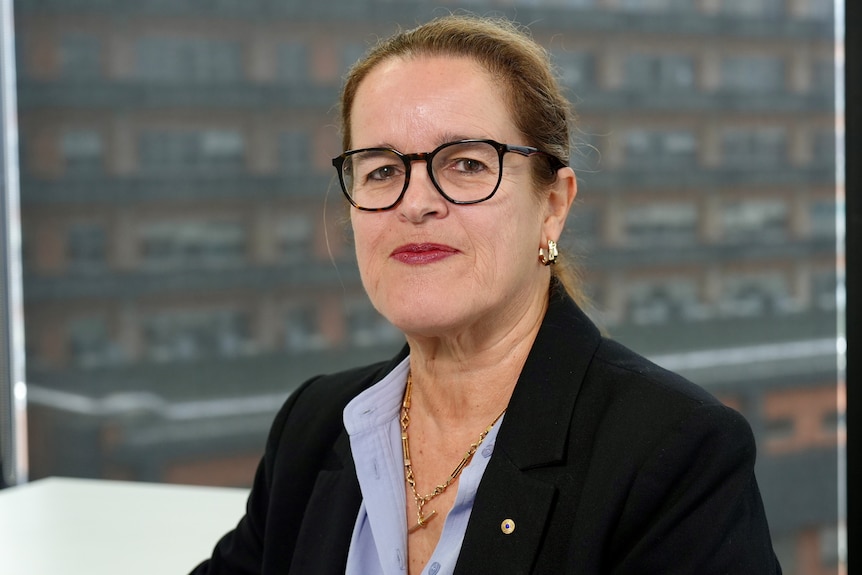 A woman smiles at the camera.