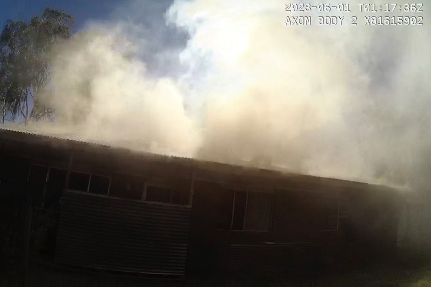 Body-worn camera footage of smoke billowing from a building's roof