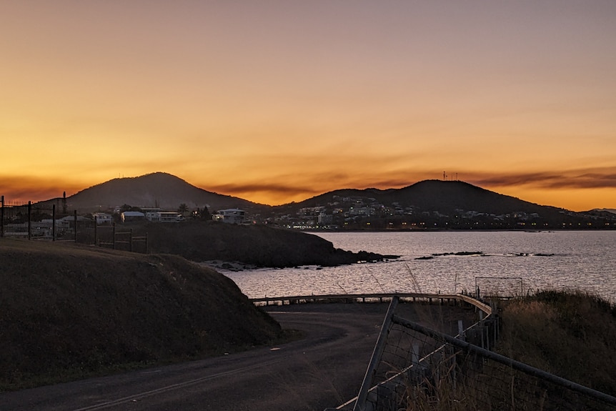 Sunset over Yeppoon in central Queensland showing hills and ocean.