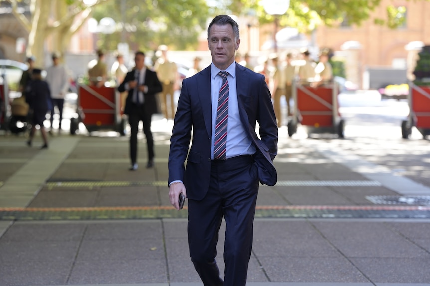 Chris Minns wearing a dark suit and tie.