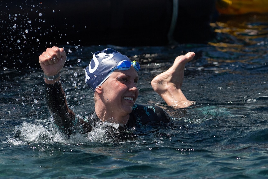 Moesha Johnson punches the air in the water