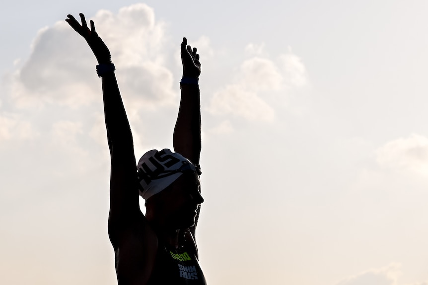 Moesha Johnson holds up her hands in shadow