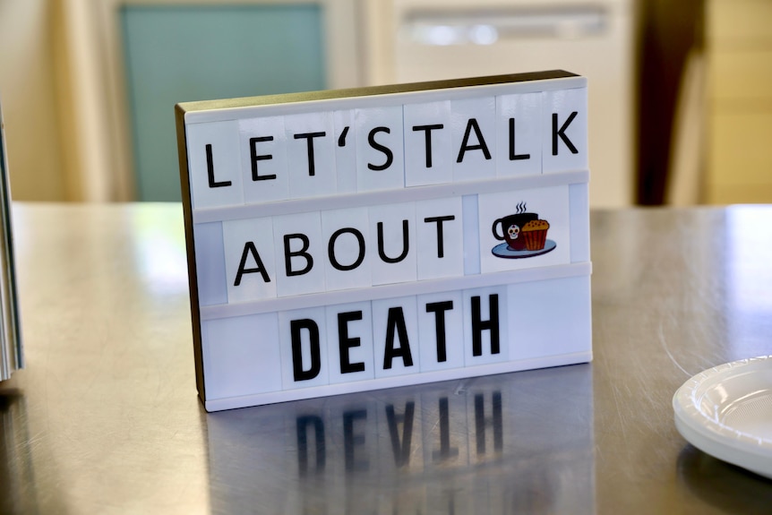 a sign saying let's talk about death