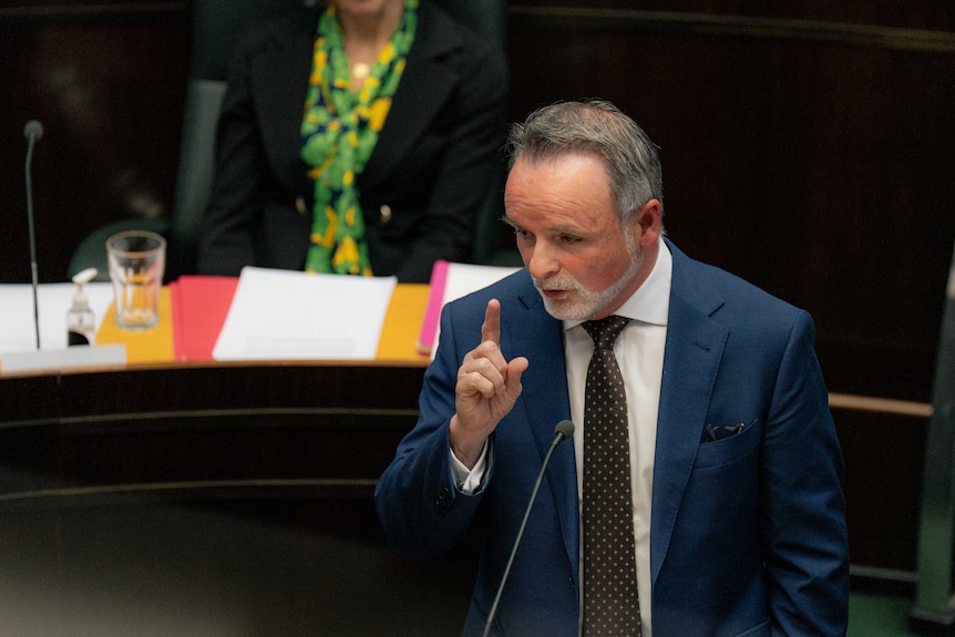 Man speaks at a lectern